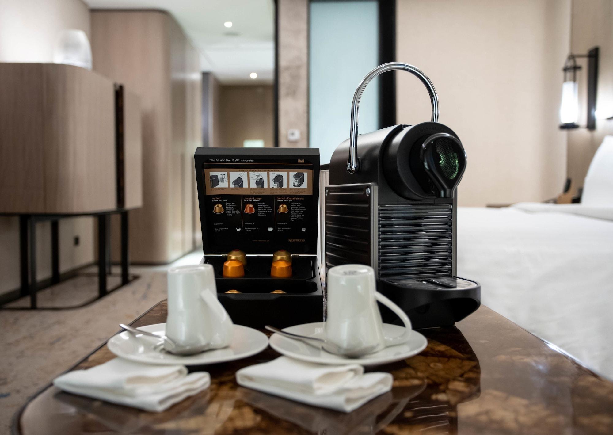 Hotel Conrad Manila Pasay Exterior foto A Nespresso coffee machine in a hotel room